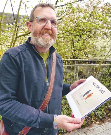 Peter Seybold Ein Mann hält ein Schaubild.