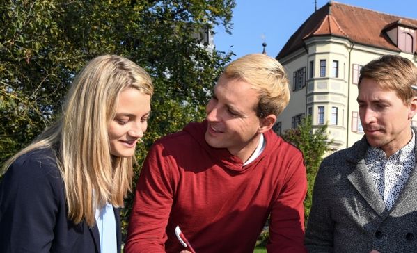Das Bild zeigt drei Kursteilnehmer bei einem Outdoor-Kurs vor Corona
