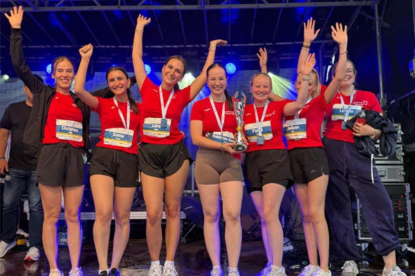Firmenlauf Eine Gruppe Auszubildender jubelt auf der Bühne.