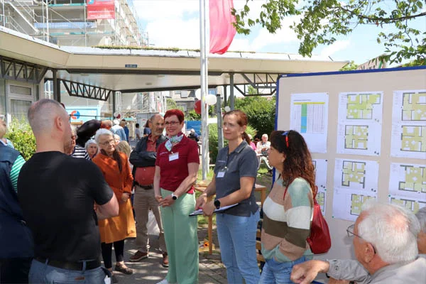 Pflegecampus Eine Personengruppe vor einer Infotafel.