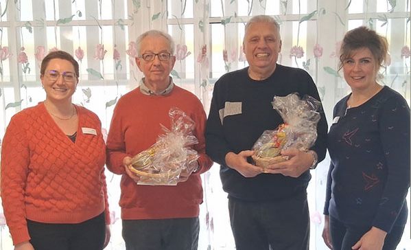 Ein Gruppenbild mit vier Personen und Geschenken.