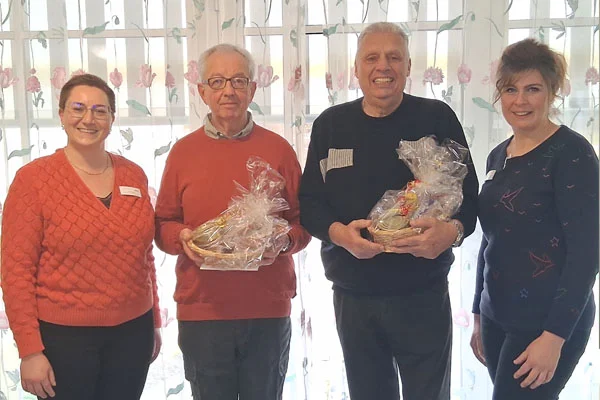 Ein Gruppenbild mit vier Personen und Geschenken.