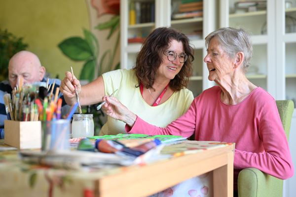 Vernissage: Senioren-Kunst der "Montagsmaler" im Haus der Pflege Magdalena Das Bild zeigt Claudia Grieb-Hoffmann mit einer Bewohnerin beim Malen