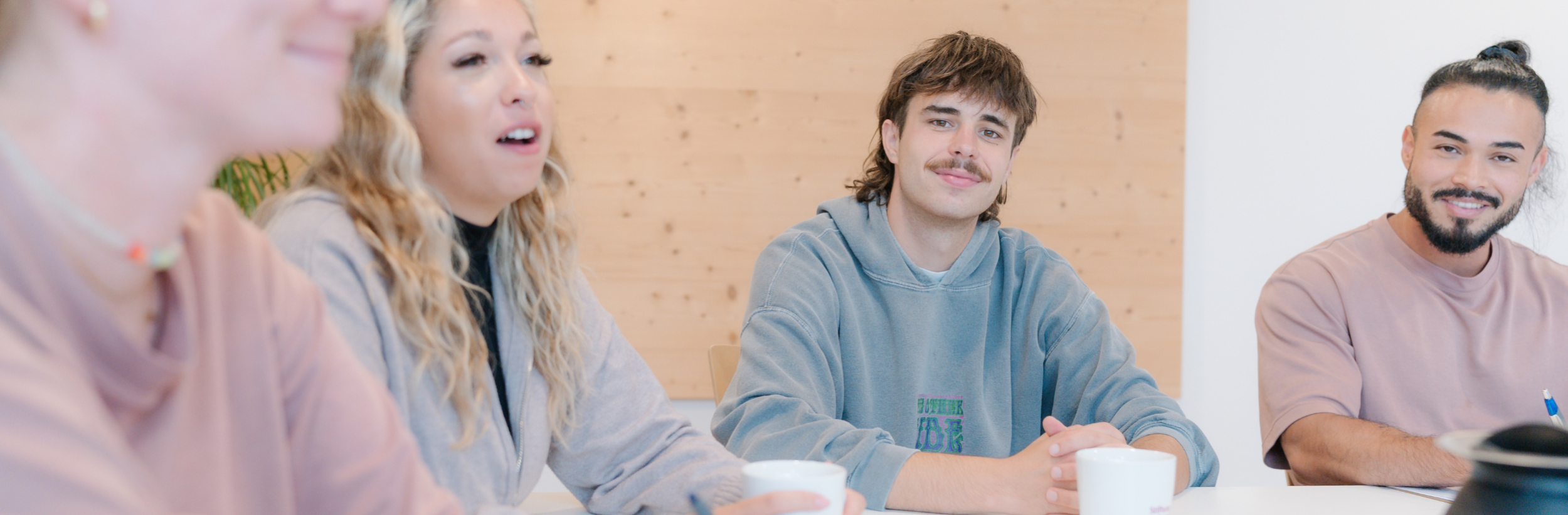 Das Bild zeigt vier Personen an einem Tisch